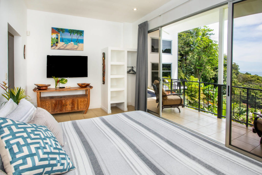 This stunning bedroom has handcrafted wooden furniture and a gorgeous view from the balcony.