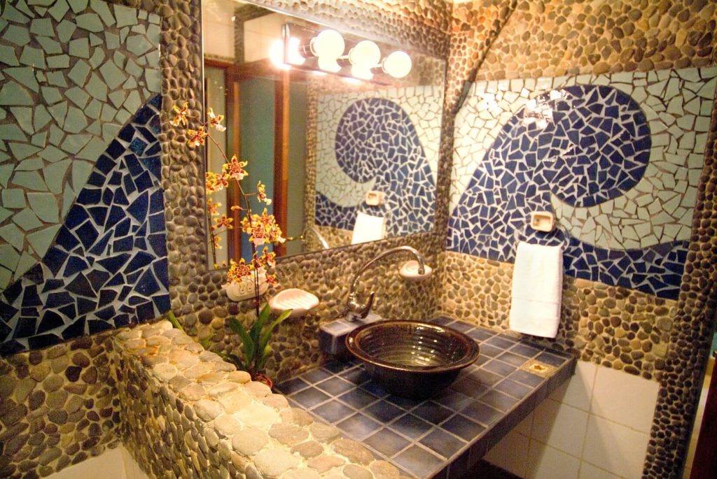The bathrooms in this luxury rental are individual works of art like this incredible mosaic of chipped tile.