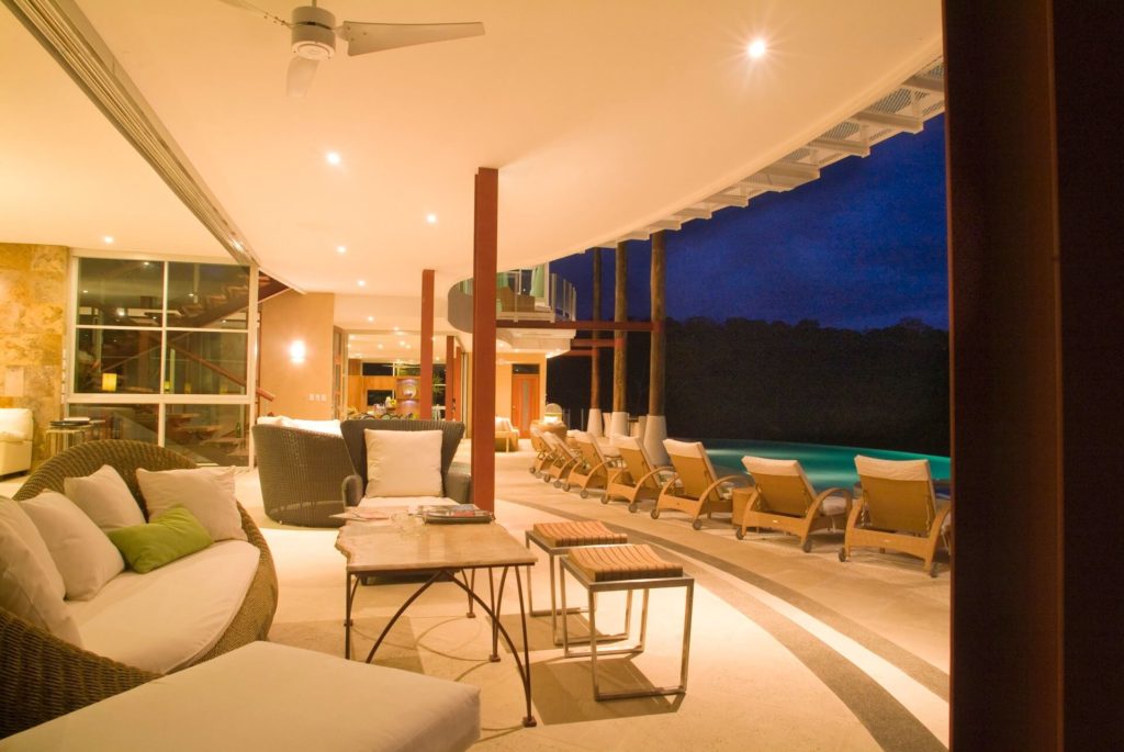 The open-plan living room facing the pool and deck has enough seating for your whole group to relax together.