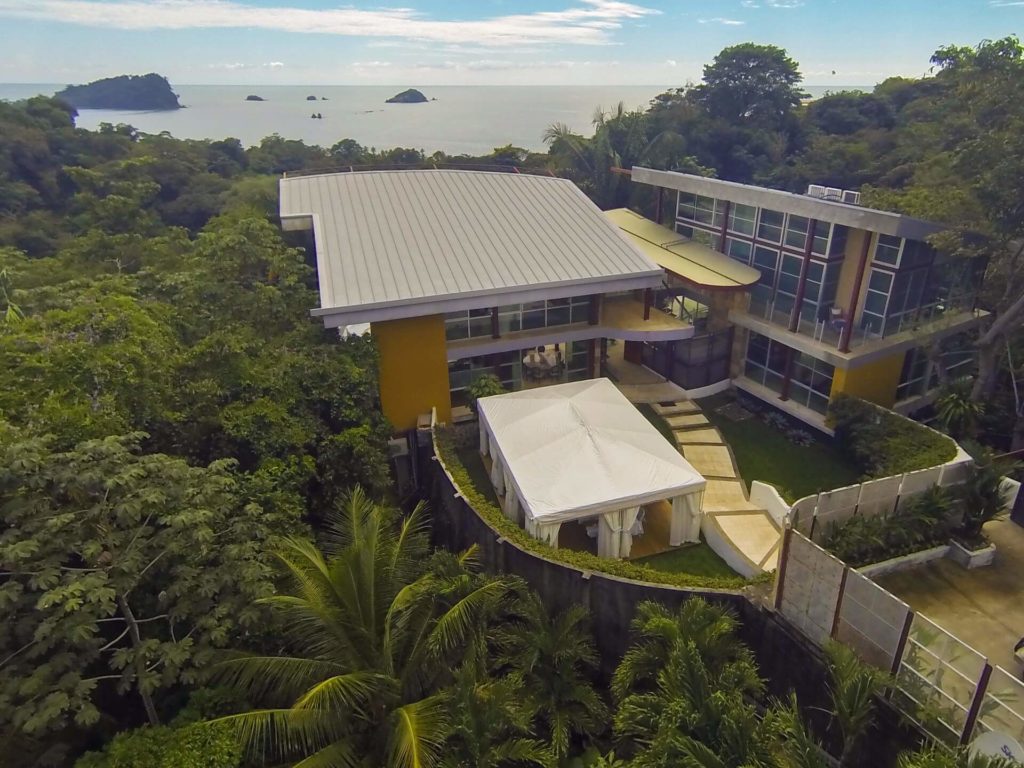 This stunning tropical mansion sits in a secluded setting near the beach embraced by vibrant rainforest.