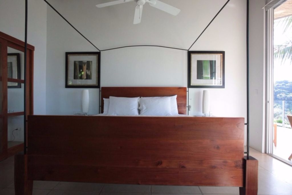 Upper-level king bedroom with an exquisitely-crafted wooden poster bed.