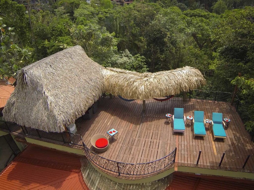 The amazing rooftop sky deck has space for sunbathing or relaxing in the shade of the tiki-style rancho. 