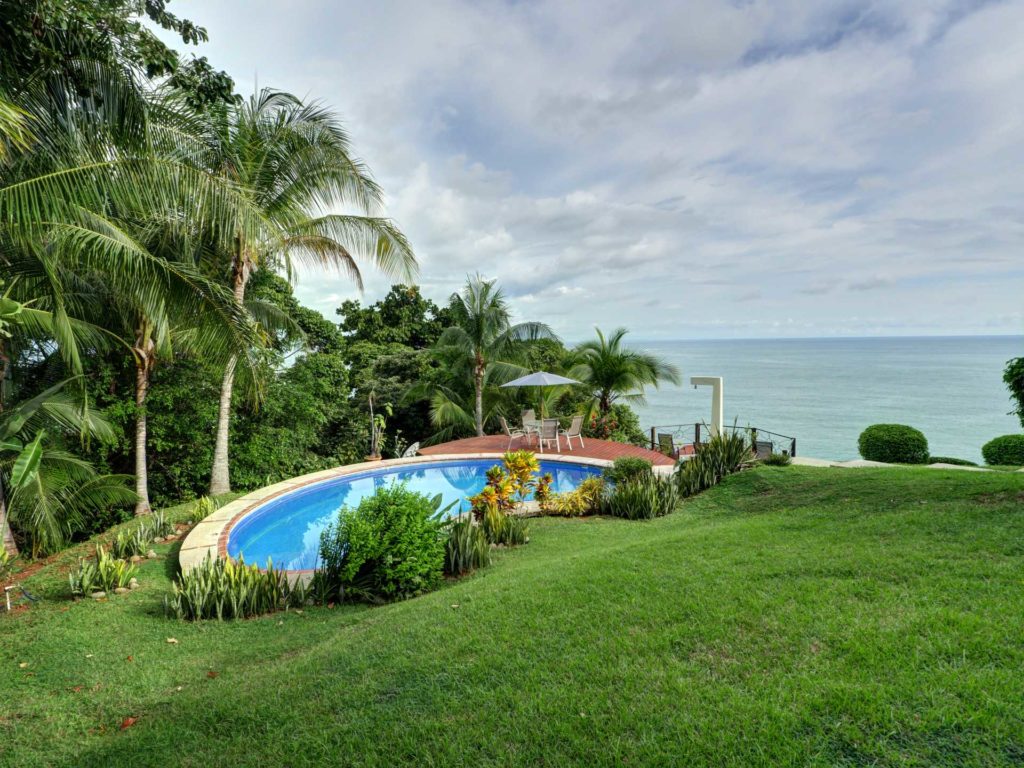 The carefully manicured lawn reaches down to your private pool from the villa.