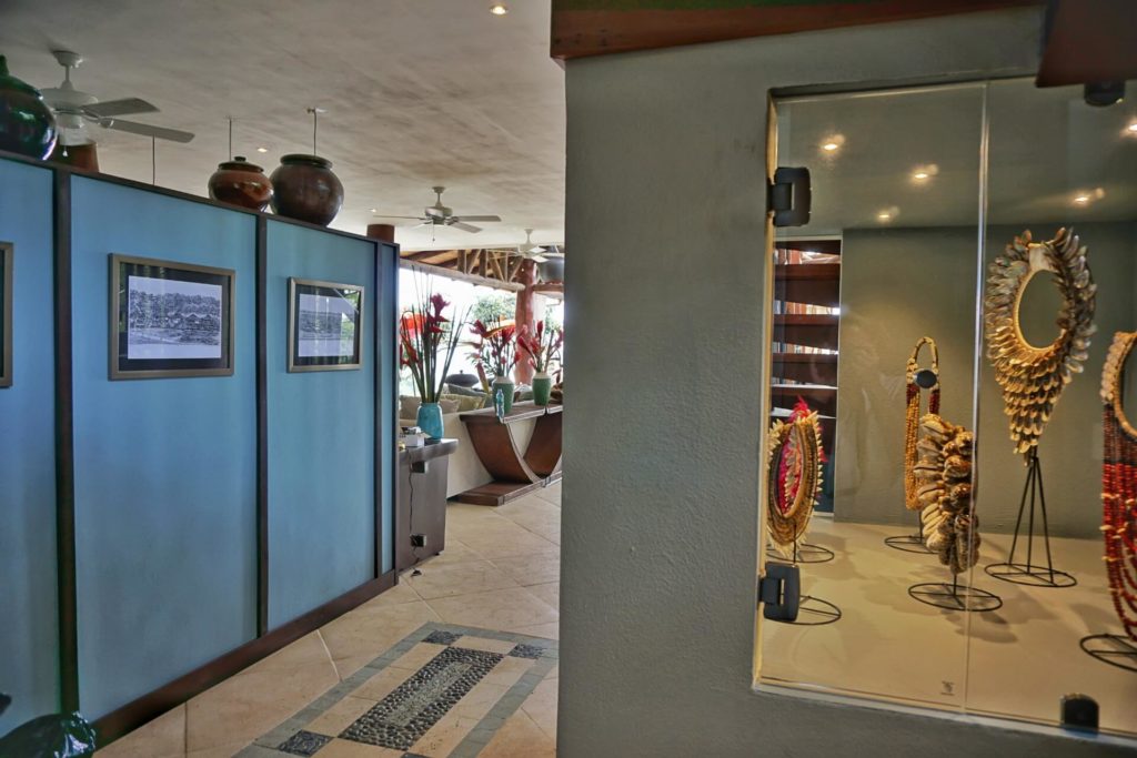 The entrance to the the villa is beautifully decorated with stone and tiles on the floor and artwork in a glass cabinet.