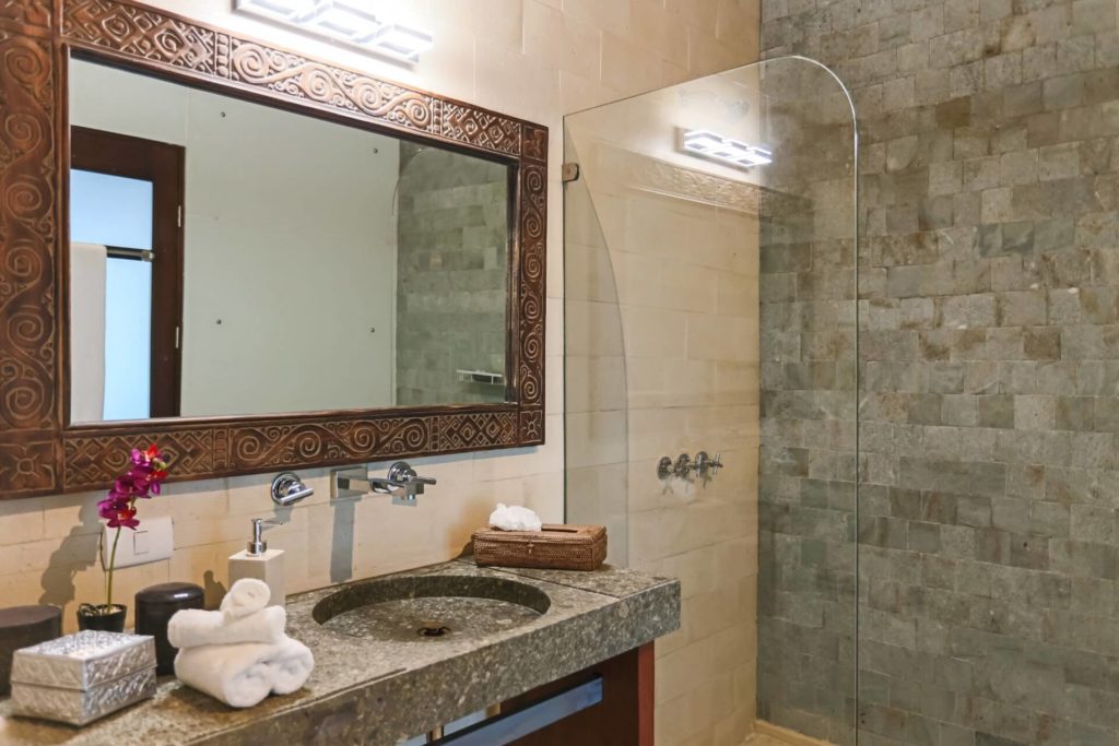 This luxurious bathroom has beautiful features of granite, stone, and tile.