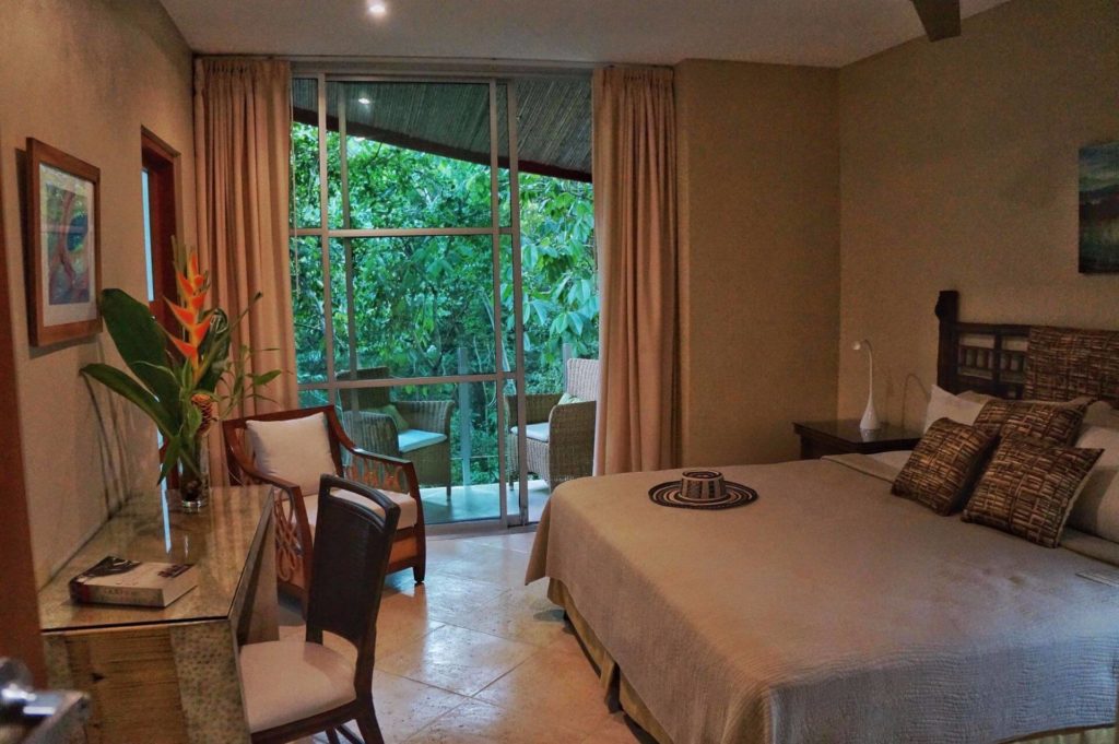 Relax in this comfortable bedroom with a natural vibe and the rainforest right outside.