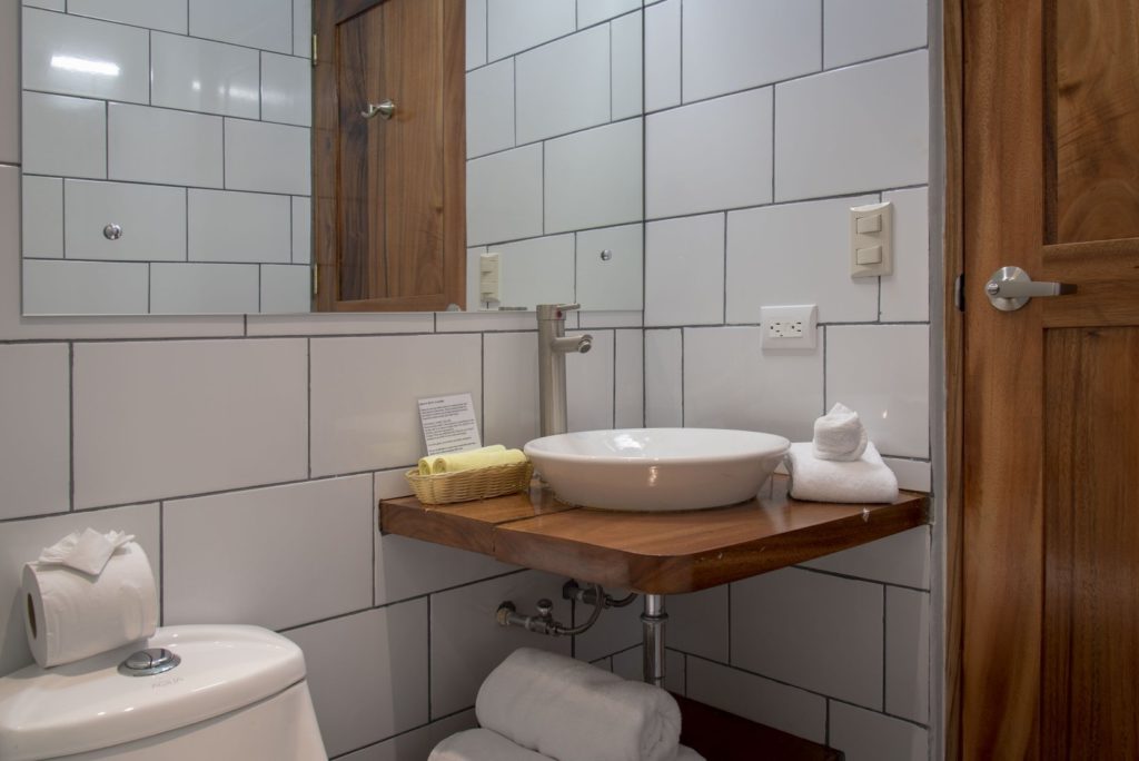 Each bathroom is uniquely designed, this one features a wooden counter with a bowl sink. 