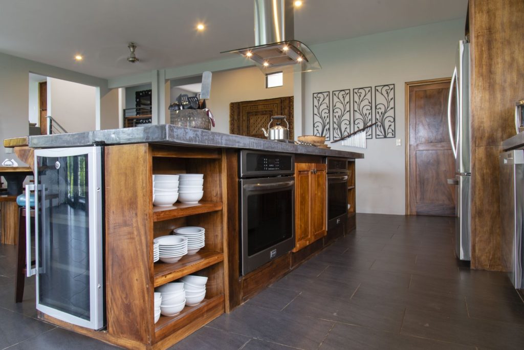 Double ovens, a wine chiller, and custom-made counter tops offer convenience and luxury in the kitchen.
