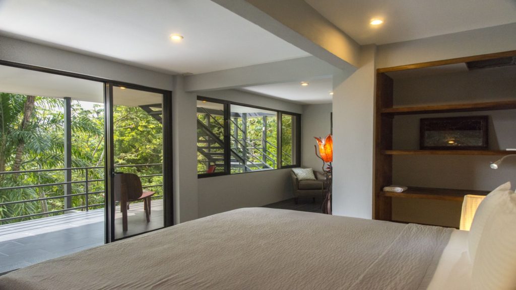 The lower level master bedroom has lots of windows and a sliding door to the balcony.