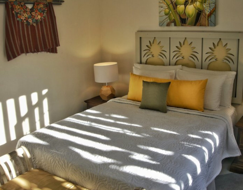 Comfortable bed with a tropical design in the guest bedroom.