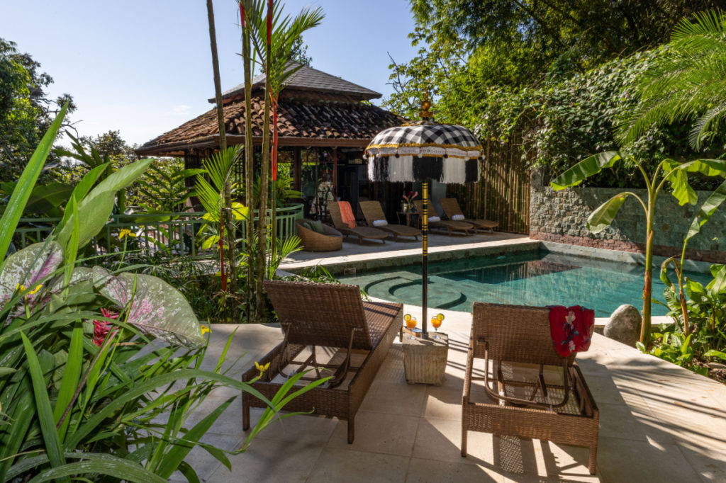 Unwind in the luxurious pool lounge area, enveloped by verdant rainforest.