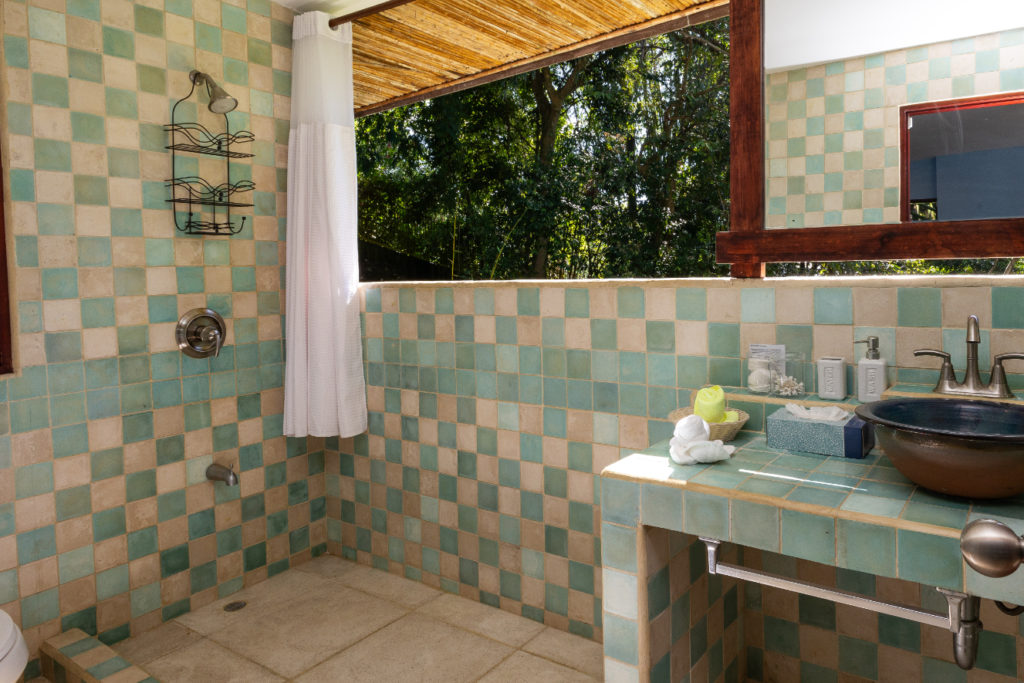Ample shower space with a jungle view.