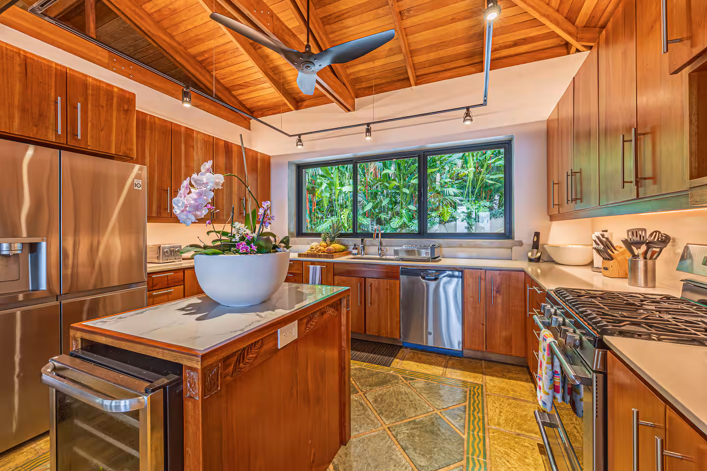 Fully equipped kitchen with wood cabinetry and modern appliances in a villa near Dominical, Costa Rica.