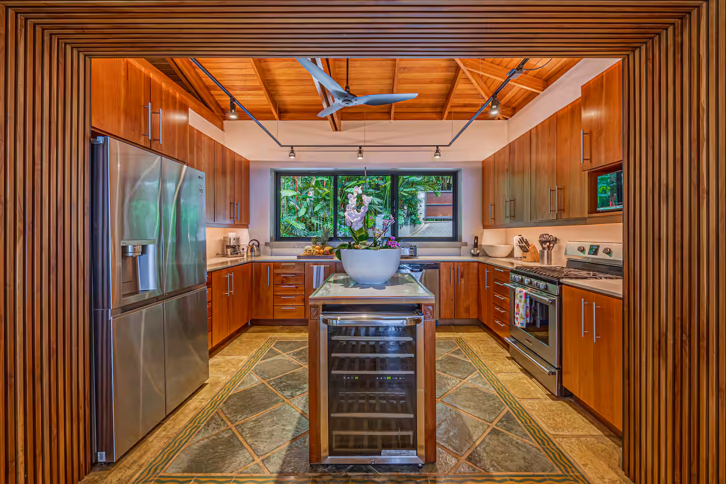 Kitchen with wood finishes and views of tropical jungle in a villa near Dominical, Costa Rica.