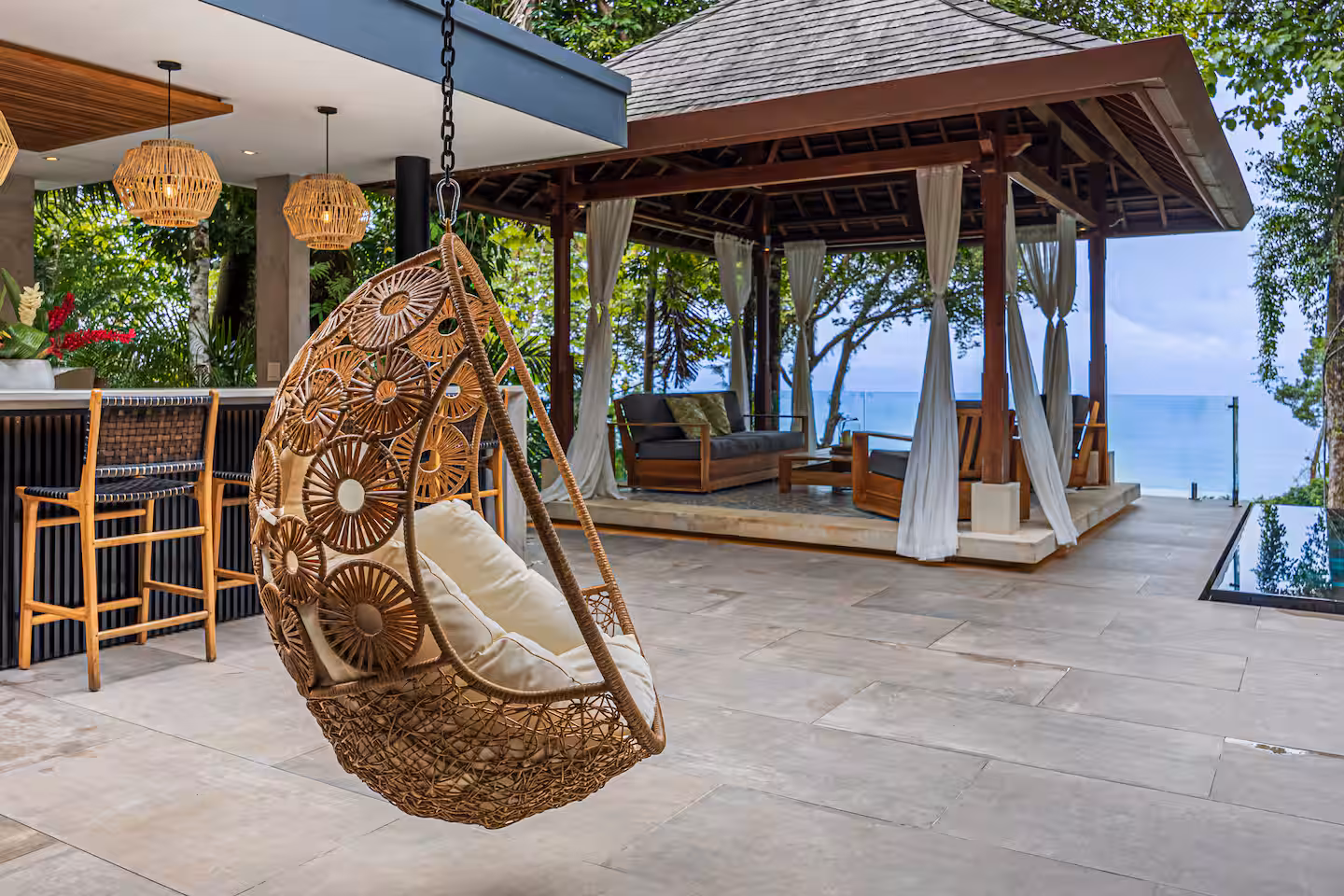 Outdoor gathering area with bar and shaded gazebo overlooking jungle and ocean near Dominical, Costa Rica.