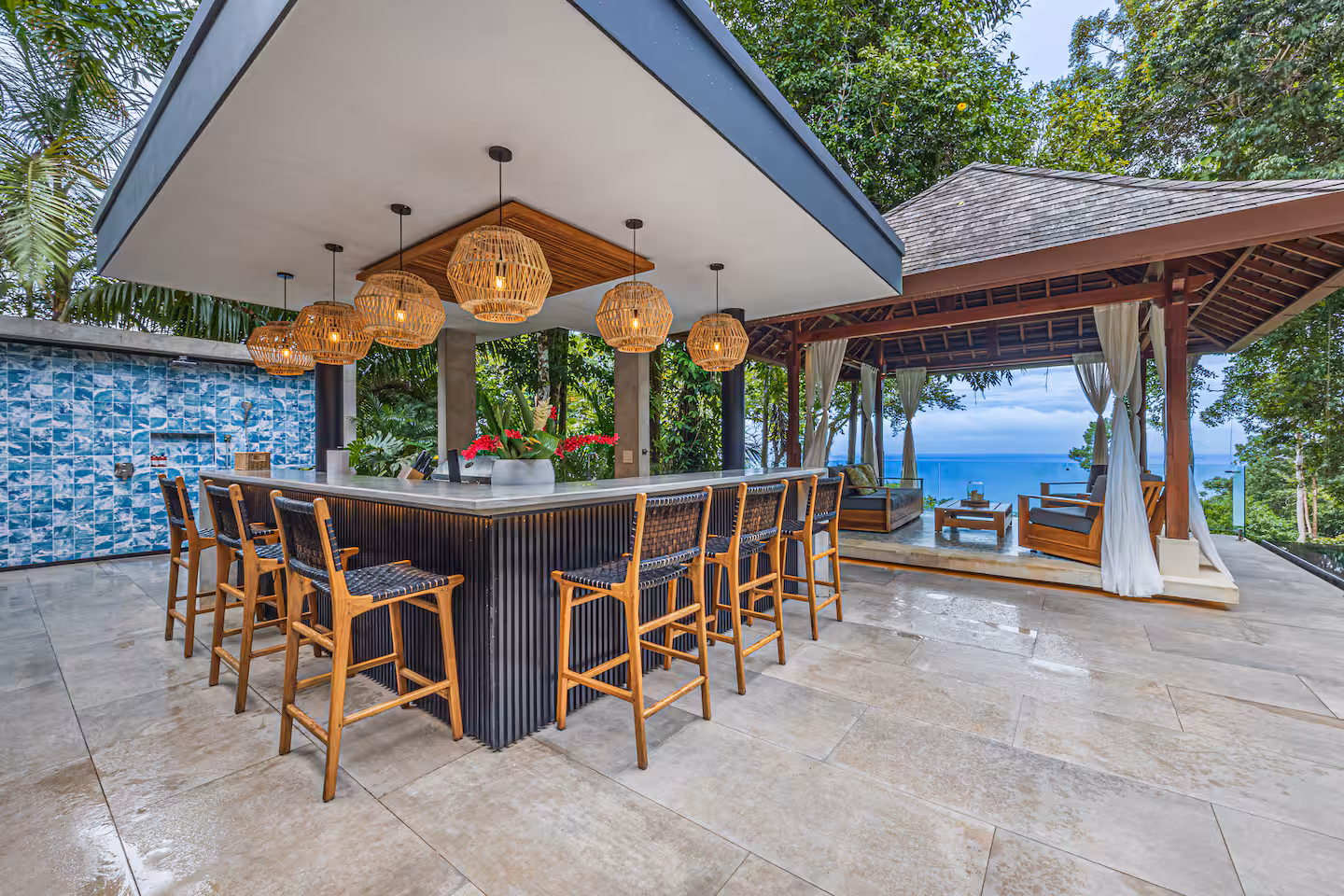 Covered outdoor bar and lounge with seating and ocean views near Dominical, Costa Rica.