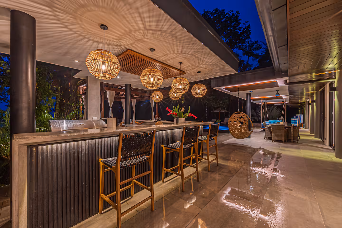 Outdoor bar illuminated at night with jungle surroundings near Dominical, Costa Rica.