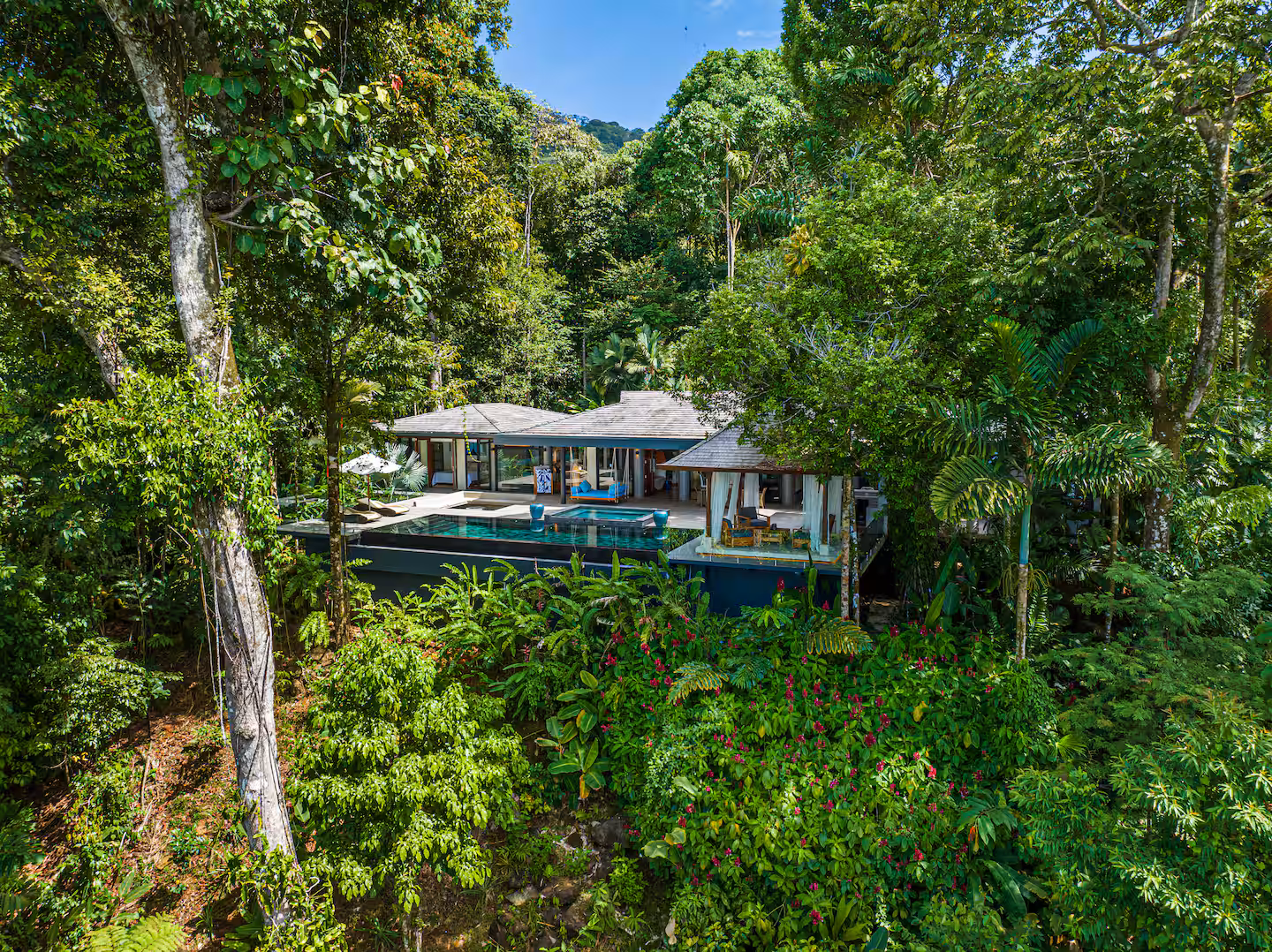 Outdoor lounge seating surrounded by tropical jungle near Dominical, Costa Rica.