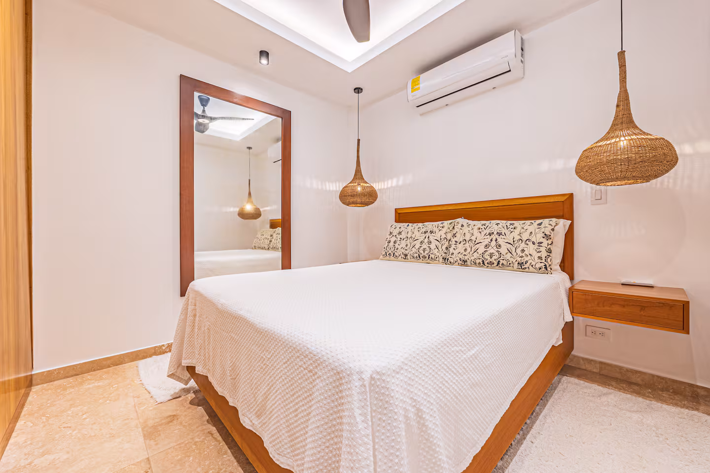 Guest bedroom with warm wood finishes and woven pendant lighting near Dominical, Costa Rica.