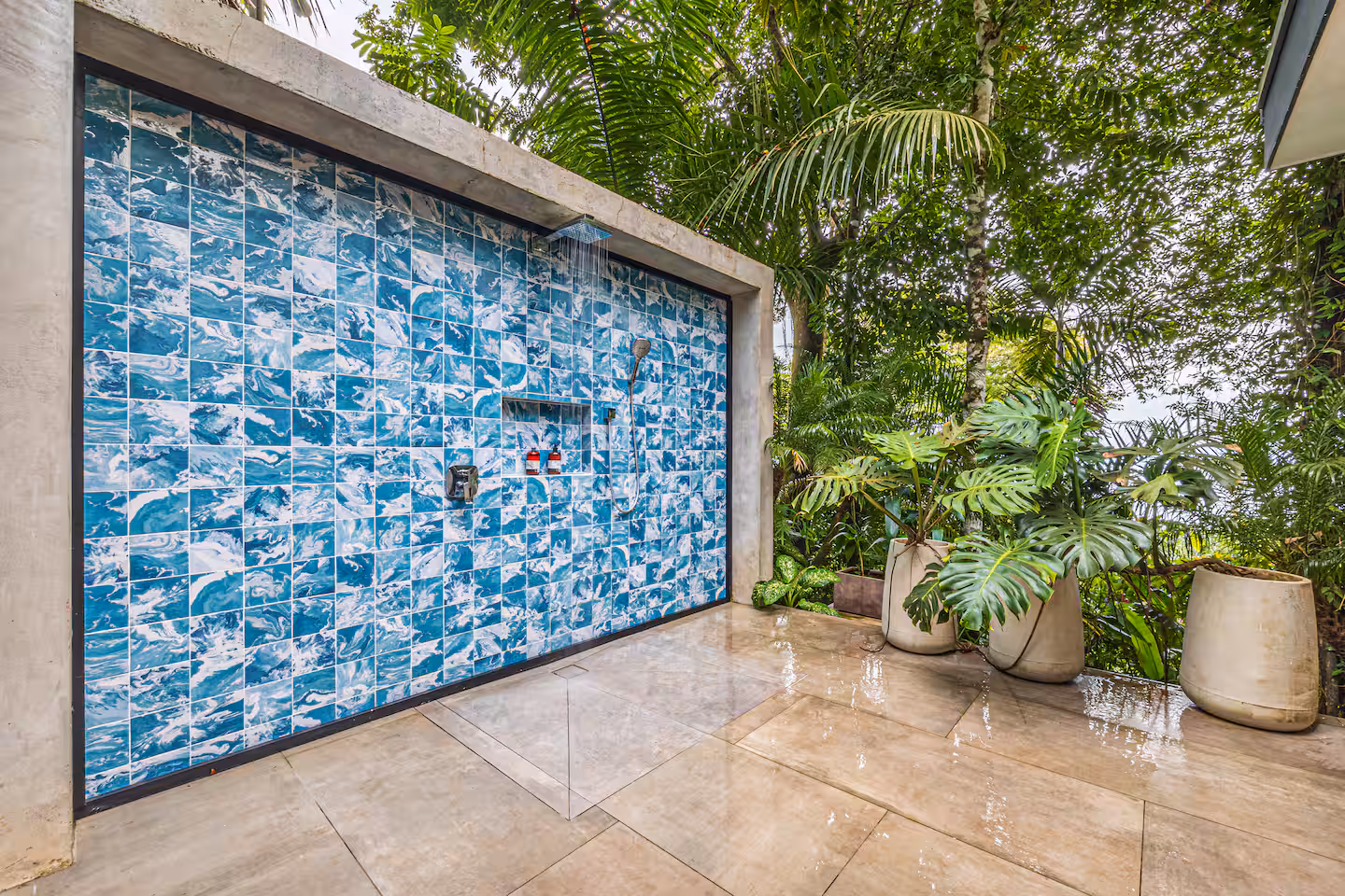 Open-air rainfall shower with handcrafted blue tile and tropical plants near Dominical, Costa Rica.