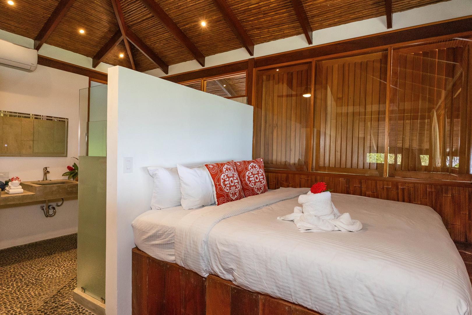 Tropical guest bedroom with ensuite bathroom and wood finishes in Manuel Antonio Costa Rica