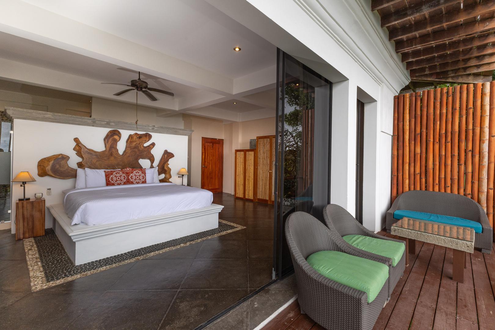 Luxury master suite with private terrace and handcrafted wood headboard in Manuel Antonio Costa Rica