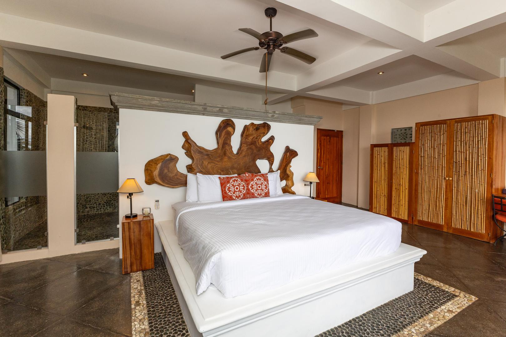 Luxury bedroom with handcrafted wood headboard and tropical design in Manuel Antonio Costa Rica