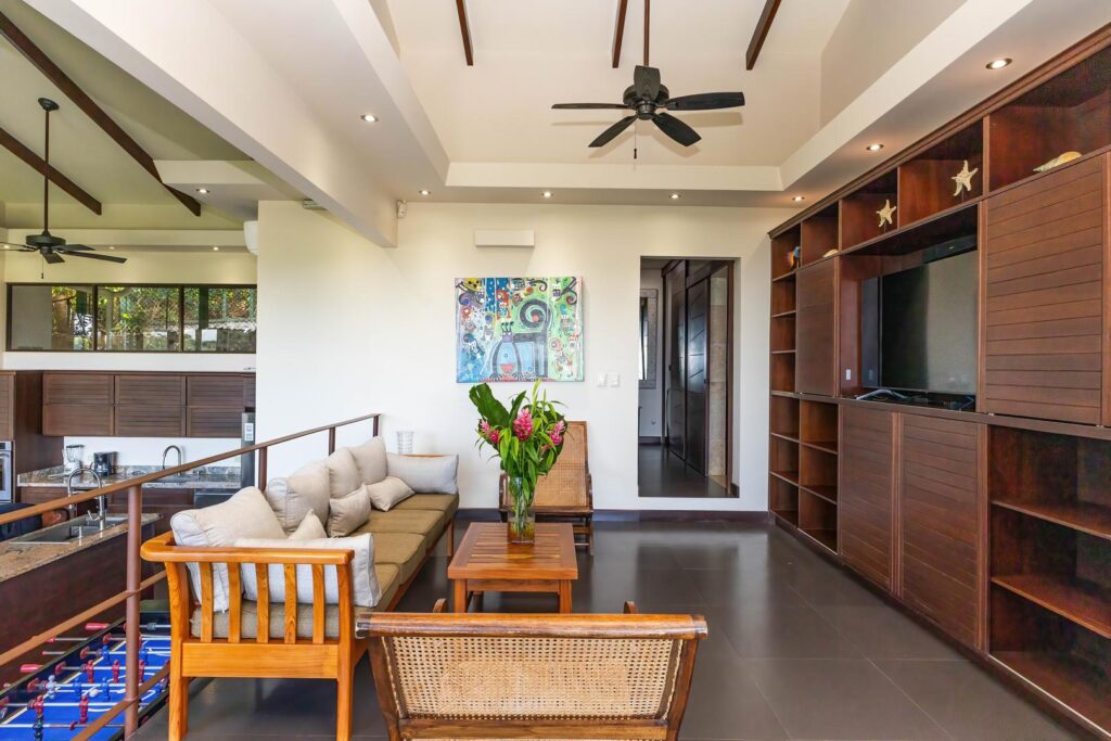 A relaxed upper-level entertainment lounge designed for movie nights, quiet downtime, or gathering together in a comfortable indoor setting.