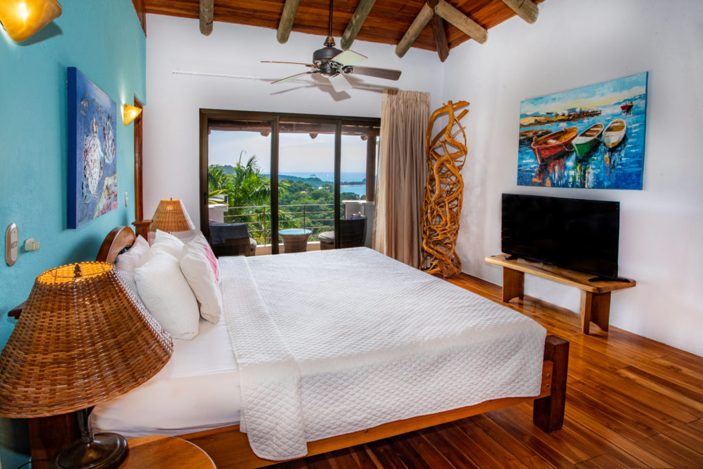 This king bedroom has a private balcony that overlooks the pool, rainforest, and ocean.