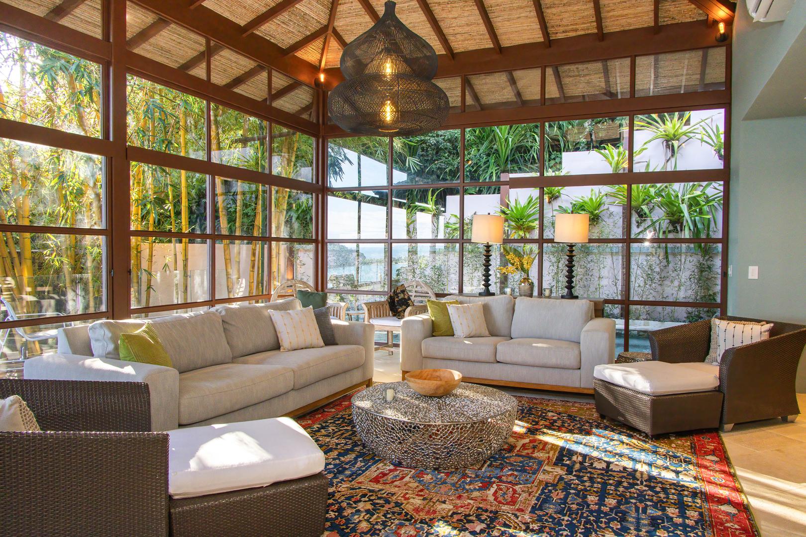 fully-airconditioned-seating area inside the new wing living room with vaulted ceiling and jungle surroundings
