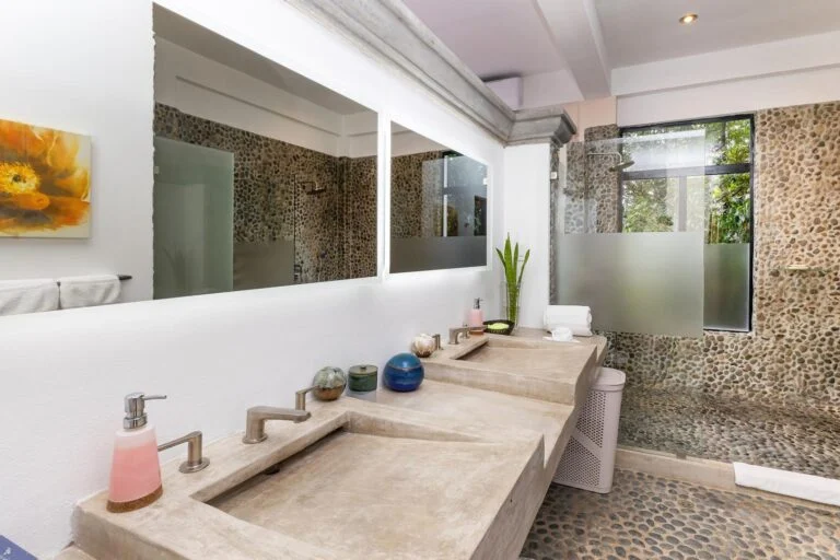 Luxury bathroom with double vanity and natural stone walk-in shower in Manuel Antonio Costa Rica