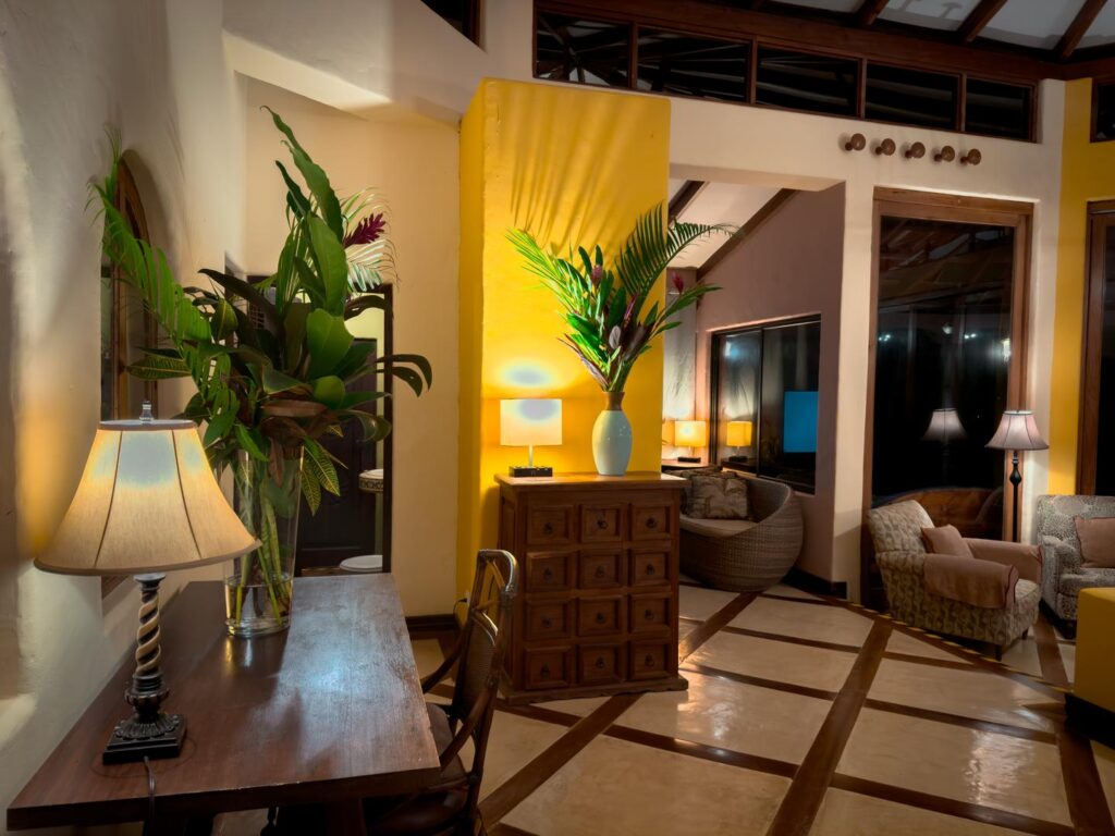 As daylight fades, the villa glows with charm and comfort.