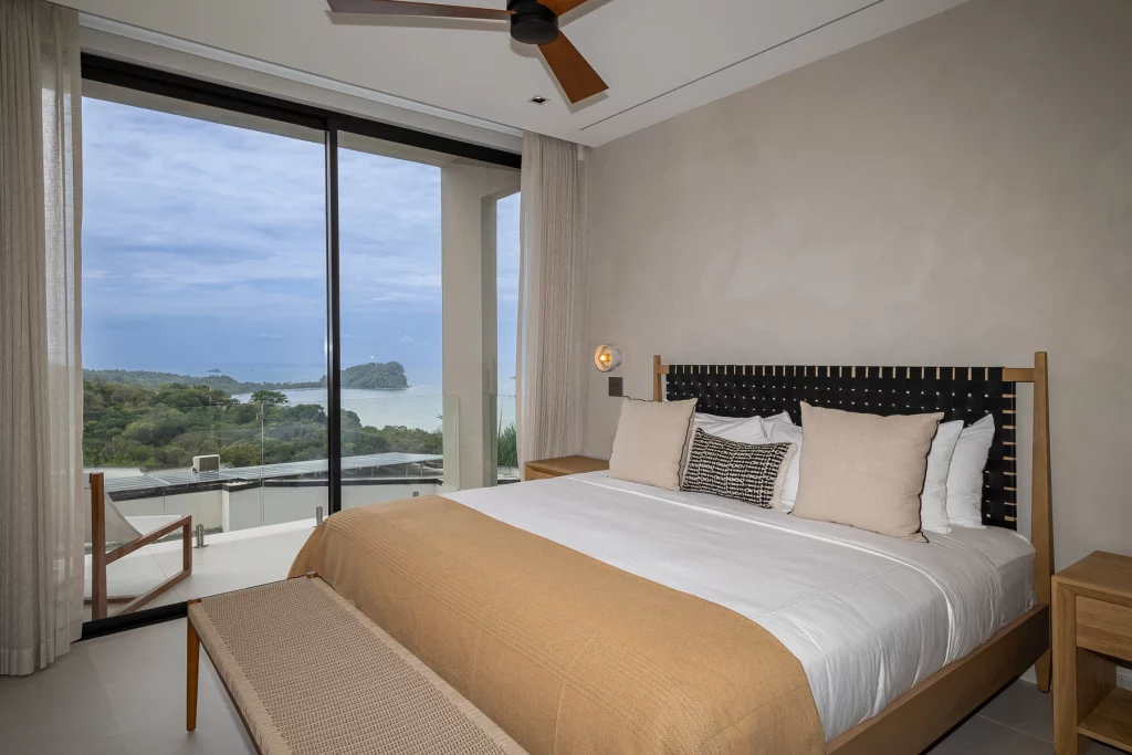 From this elegant master bedroom, the view showcases Cathedral Point in Manuel Antonio National Park.