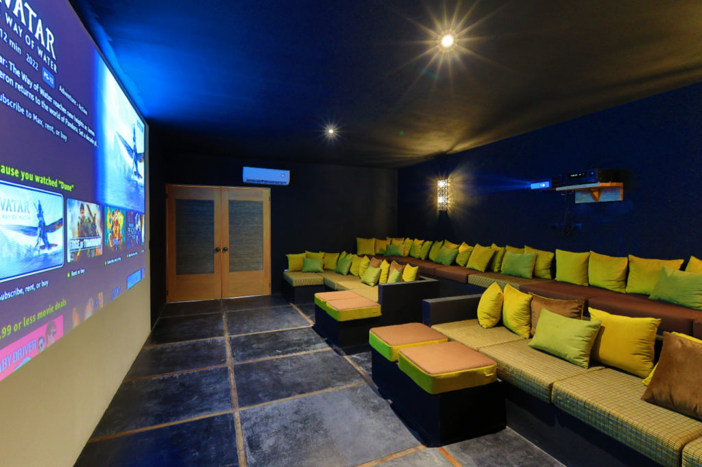 Enjoy movie nights in the fully air-conditioned cinema, complete with comfy tiered sofa seating, a digital projector, and amenities for snacks.