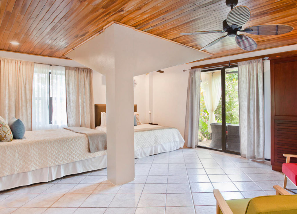 This downstairs bedroom in the smaller house features two queen beds and an ensuite bathroom