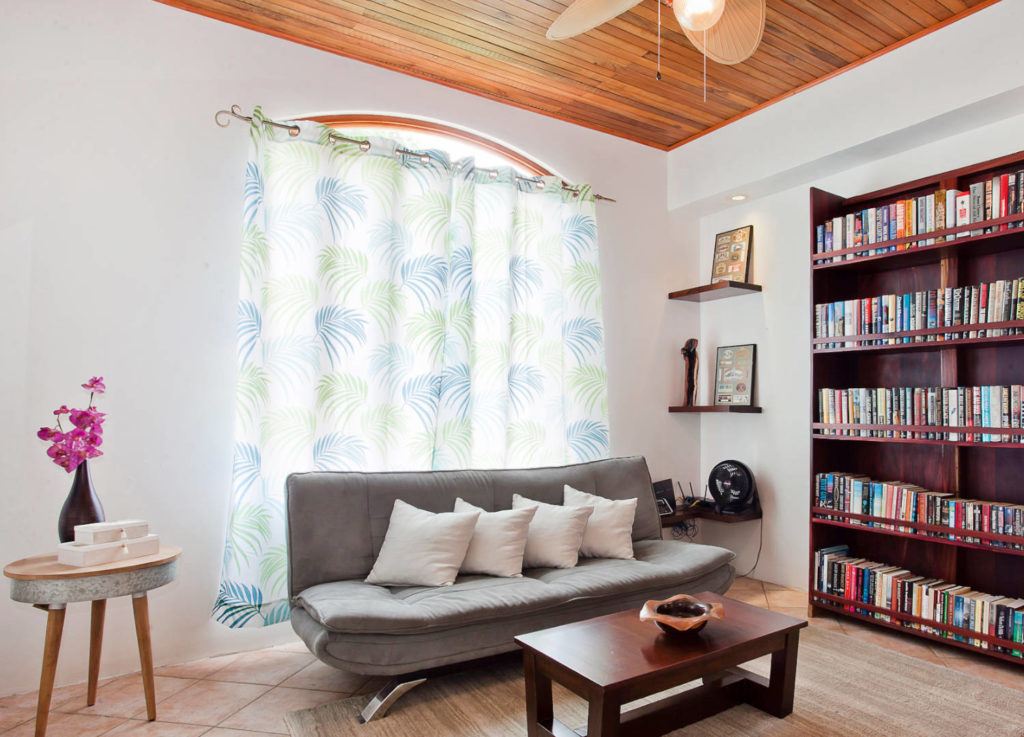 A reading area with a large book selection sits between the master bedroom and the second bedroom in the main house.