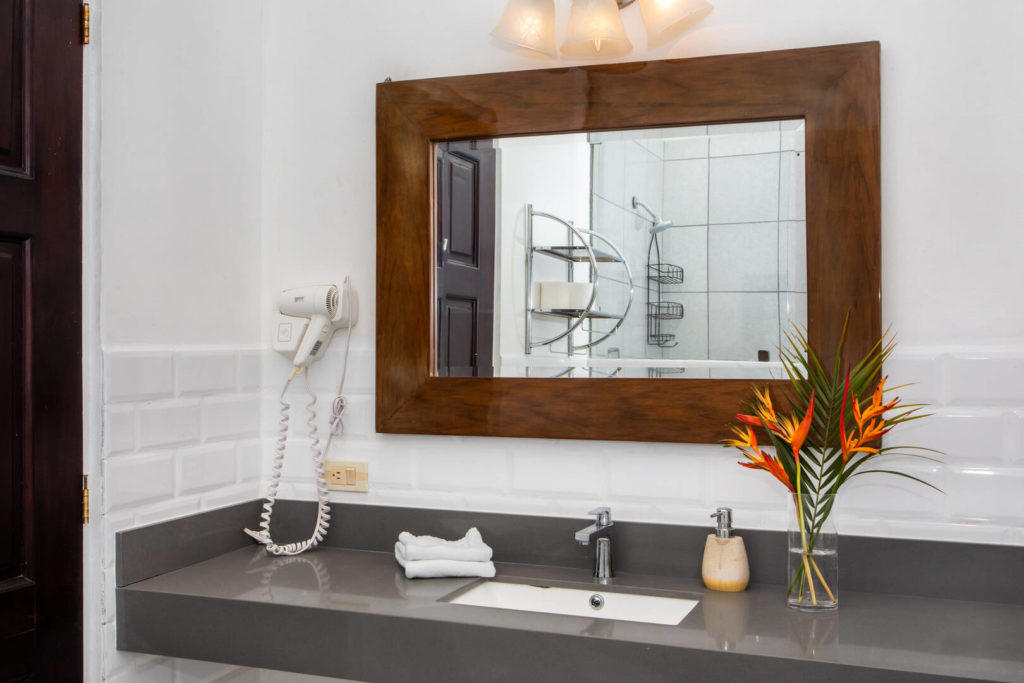 This wood-framed mirror adds a beautiful natural touch to this bathroom.