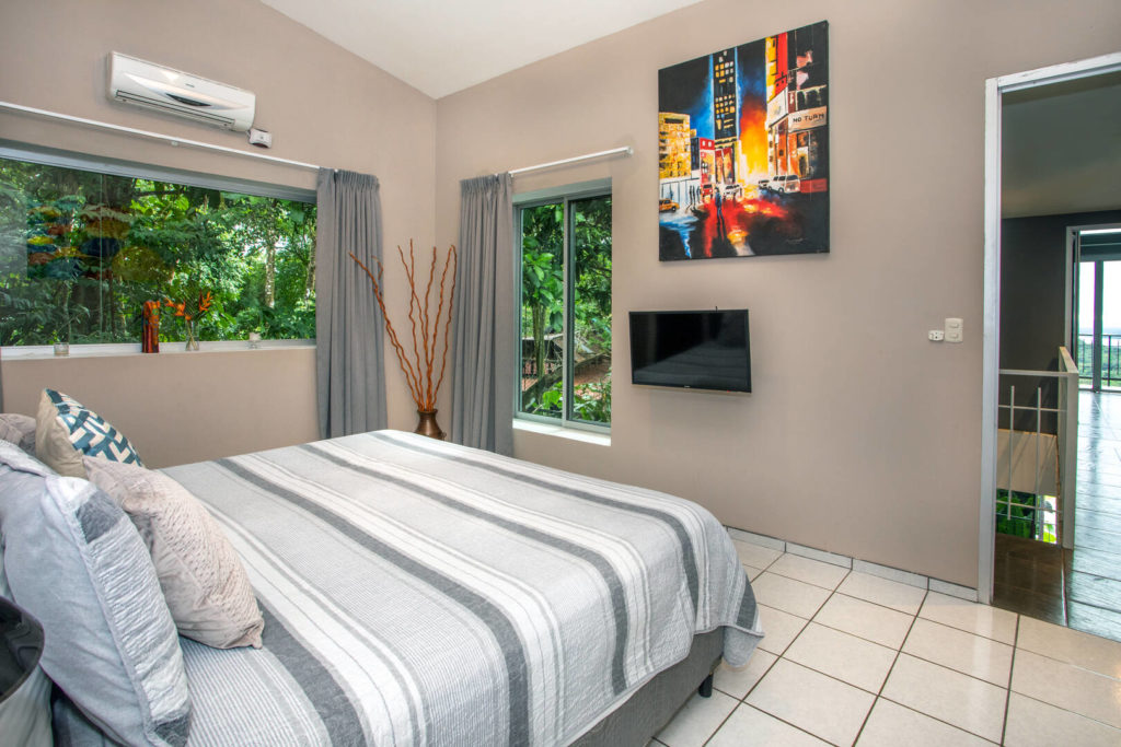 With the view outside this bedroom it feels like you are fully immersed in the lush rainforest.