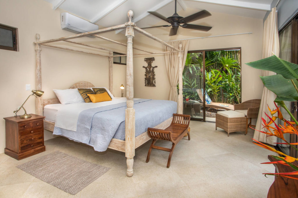 This superbly-appointed master bedroom has a beautiful wooden king poster bed.