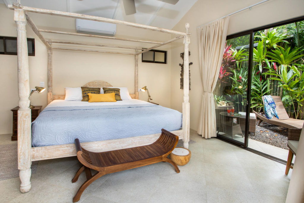 This master bedroom has both indoor and outdoor options for relaxation.