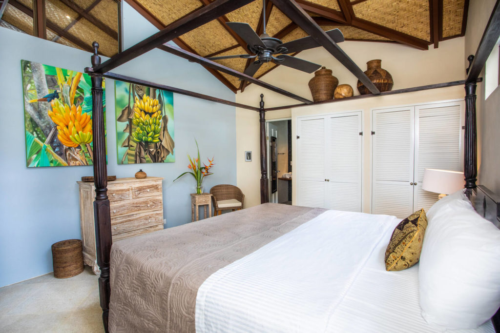 With woven vaulted ceilings and tropically-themed artwork, no detail has been left to chance in this master bedroom.