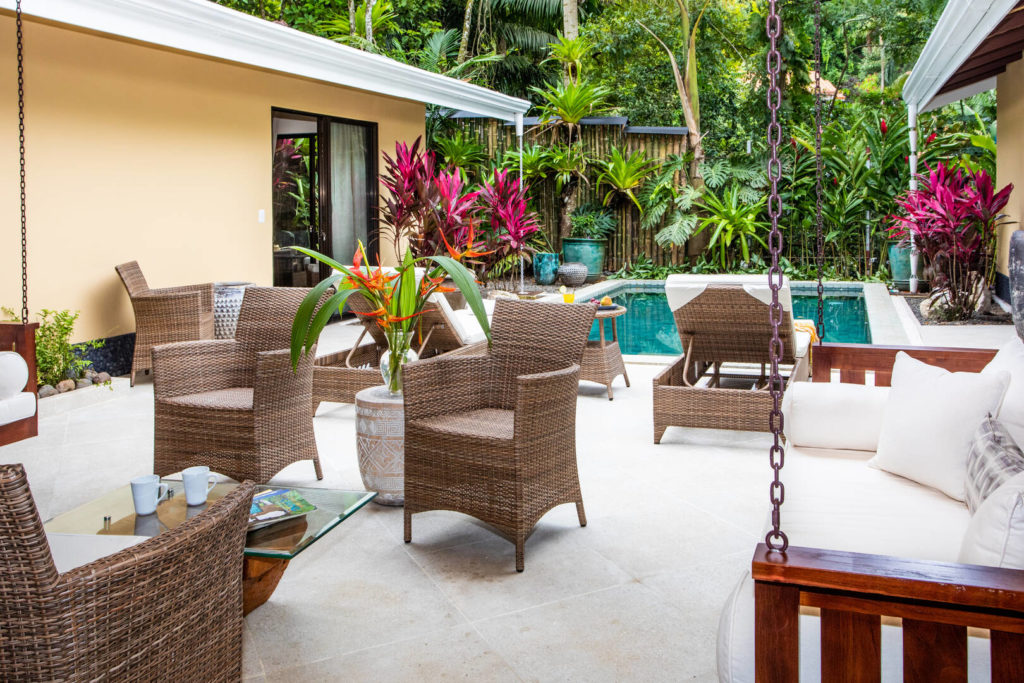 The outdoor area by the pool has plenty of seating for your group to gather including two facing porch swings.