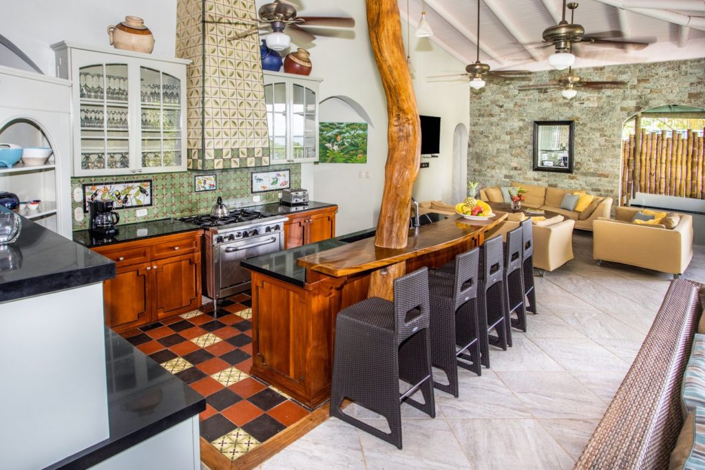 The tastefully-designed kitchen has a breakfast bar with plenty of seating and a huge tree trunk built in.