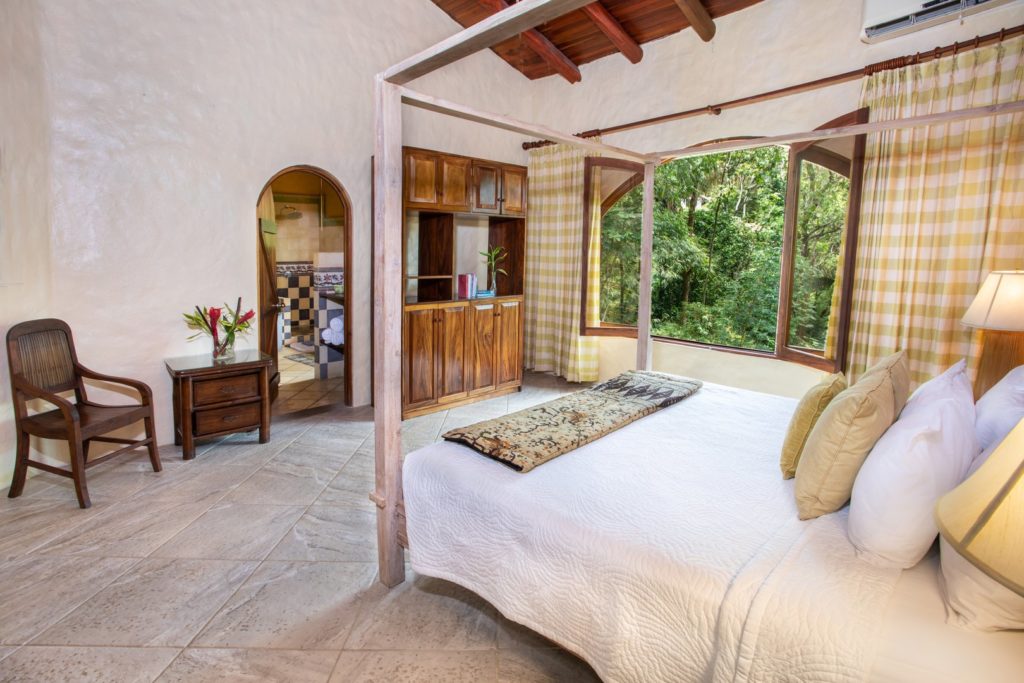 The huge master bedroom has lots of light and space with a rustic tropical ambience.