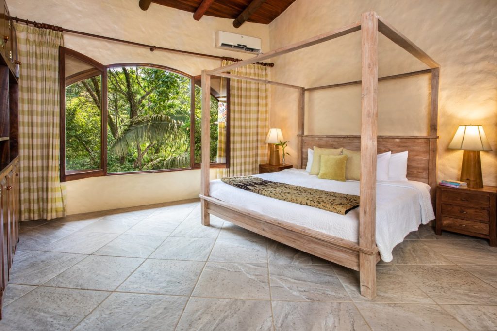The master bedroom has a beautiful king poster bed and sounds of the jungle just outside the window.