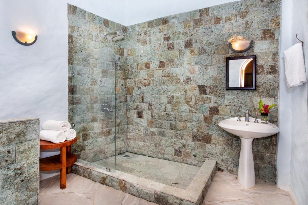 This is the full bathroom next to the games room with natural stone features.