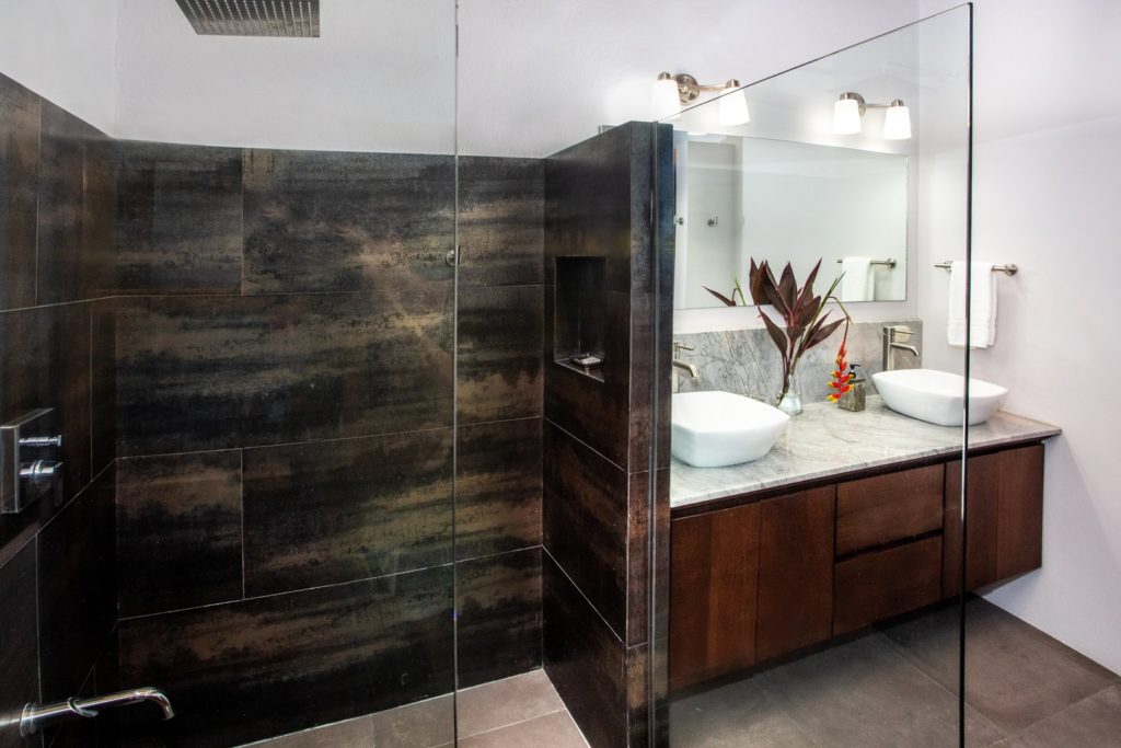 This lovely guest bathroom features his and hers sinks and a large modern shower.